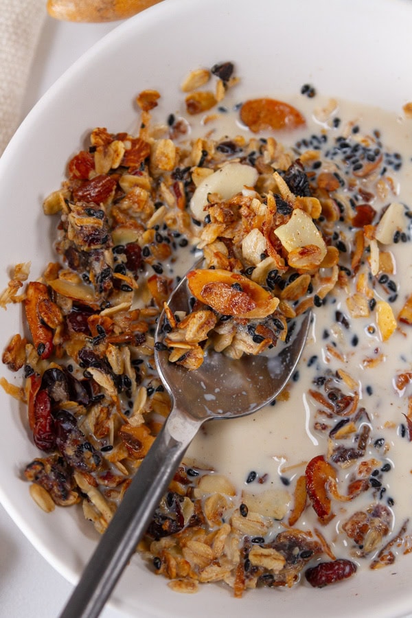 granola in milk with a spoon.