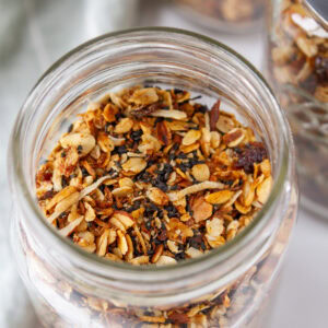square crop looking into a glass mason jar filled with granola.