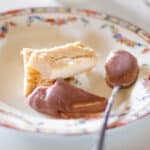 square crop of shortbread cookies on a plate with blackberry curd and a spoon.