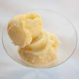 square crop of two scoops of ice cream in a martini glass.