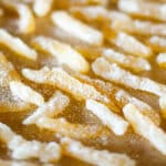 square crop of candied lemon peel drying on a silicone mat.