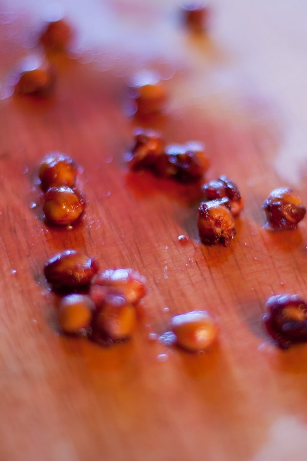 cherry pits on a wooden cutting board.