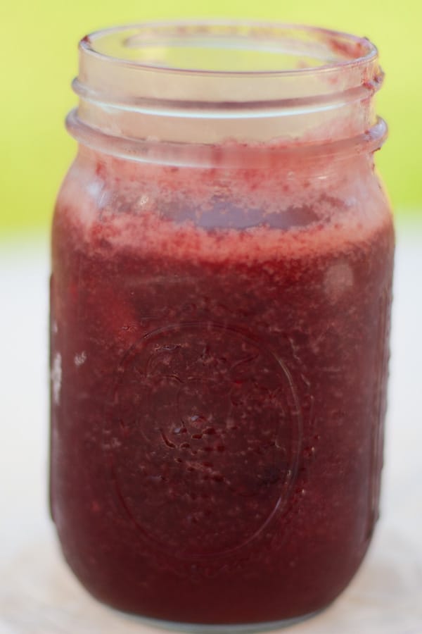 a glass mason jar filled with cherry plum jam.