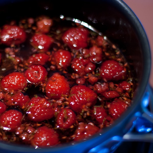 Raspberries and lime zest steeping in a pot.
