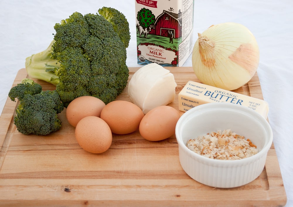 The ingredients for this quiche on a wooden cutting board.
