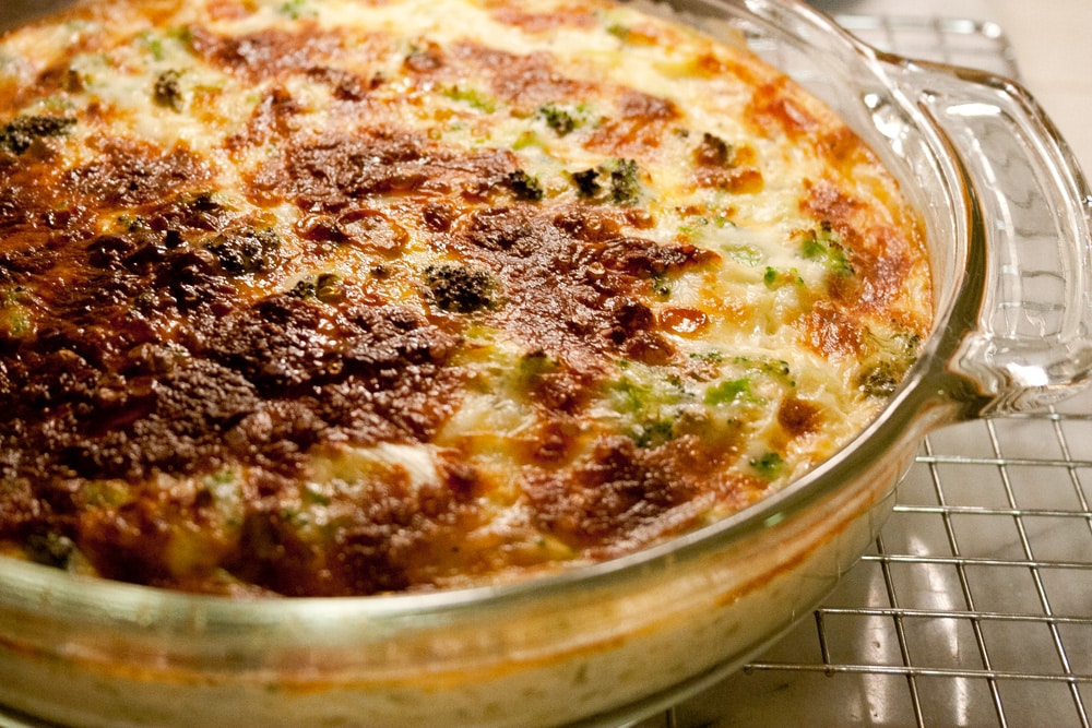 close up on a quich in a glass dish on a cooling rack.