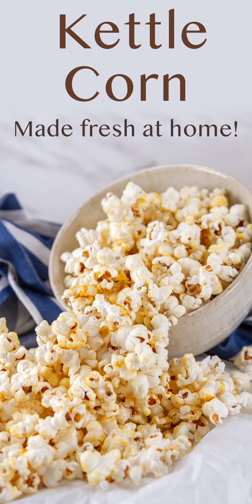 kettle corn spilled out onto a piece of parchment paper from a bowl.