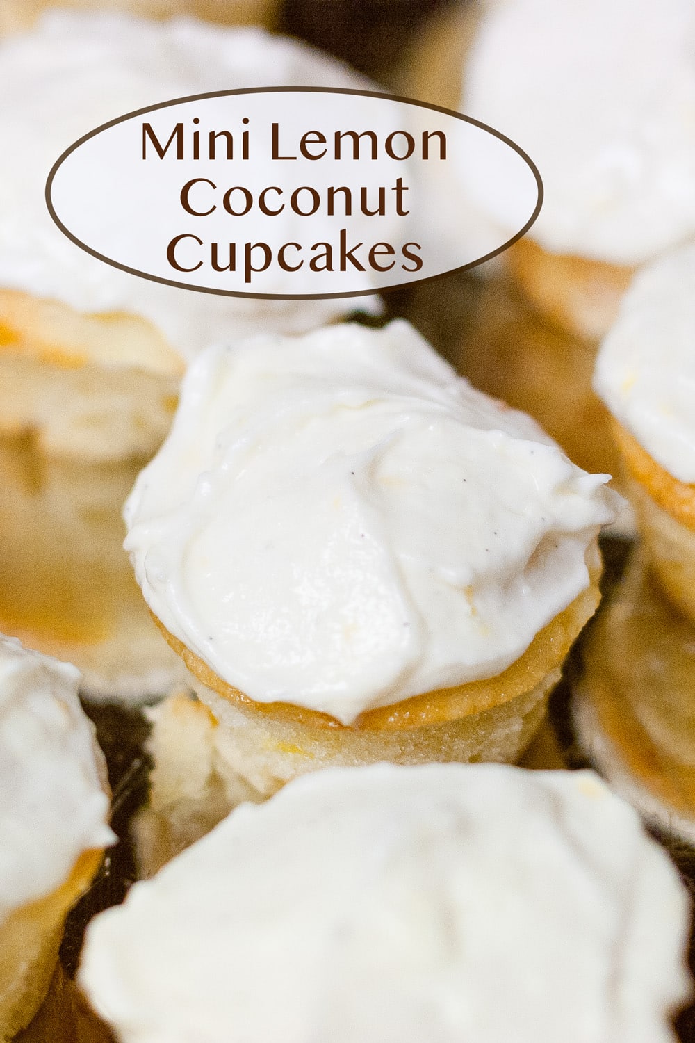 mini lemon coconut cupcakes on a silver metal tray.