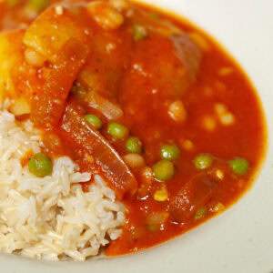 square crop of stew on rice in a bowl.