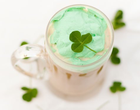 looking down on green whipped cream on a drink mug