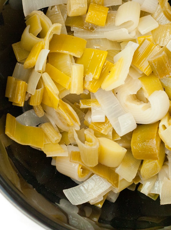 cooked leeks in a black bowl.