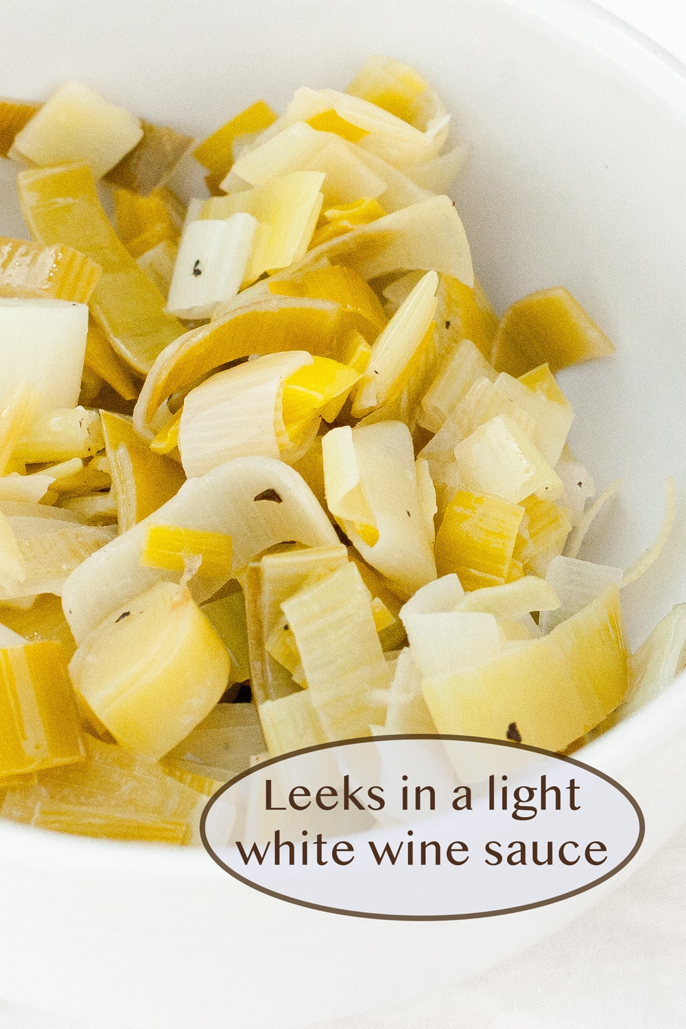 cooked leeks in a white bowl.