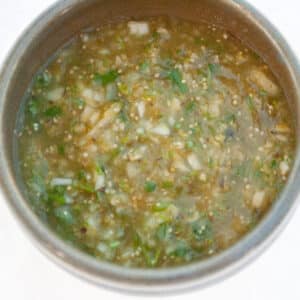 looking down into a bowl filled with tomatillo salsa verde.