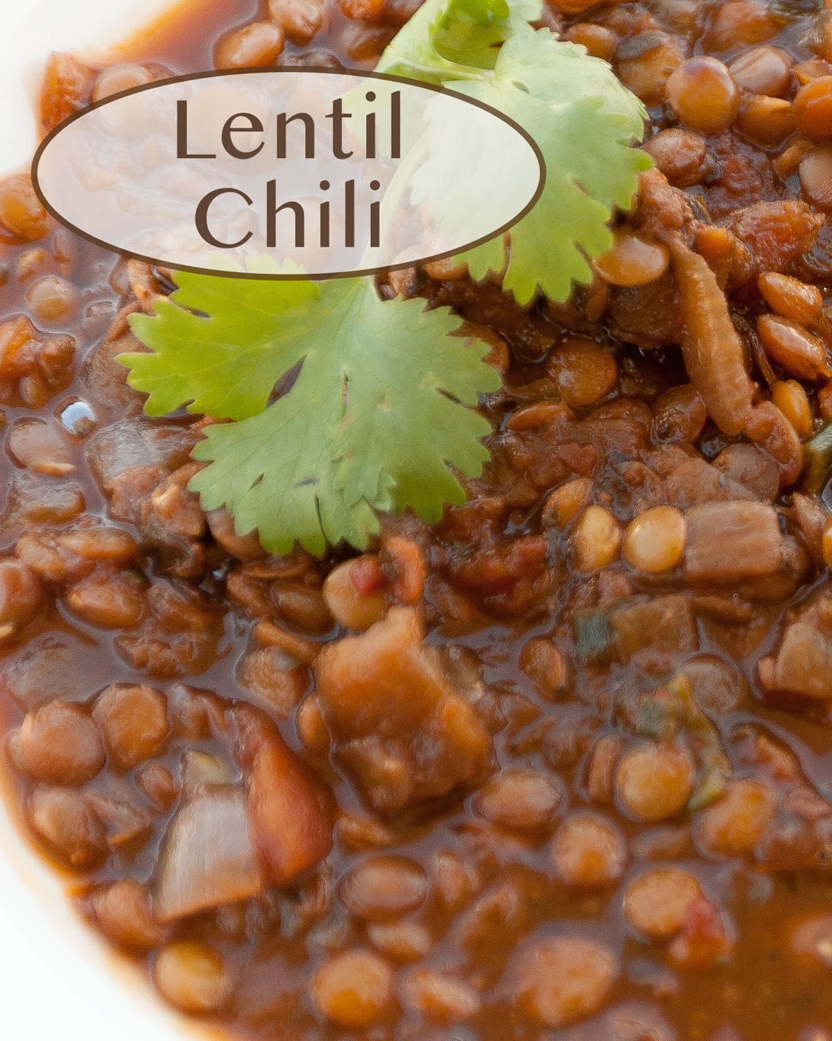 close up on a bowl of lentil chili garnished with cilantro.