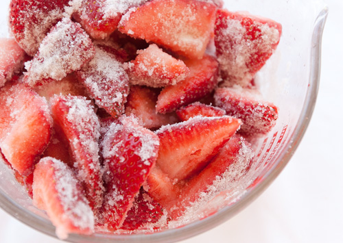 cut strawberries with sugar on the.