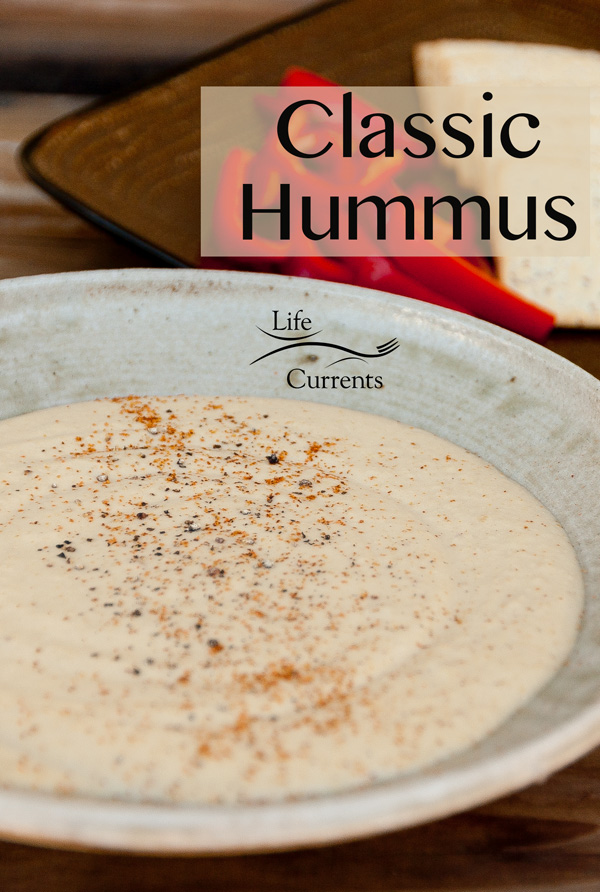 Creamy hummus in a bowl with the title "classic hummus" in the upper left.
