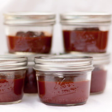 small jars with ketchup in them.