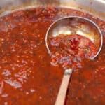Homemade Spicy Tomato Chutney in a pan with a ladle.
