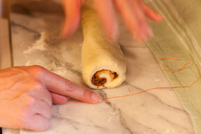 the trick or secret to cutting the cinnamon rolls: cinnamon rolls with vanilla icing: Cinnamon Rolls, a tutorial for rolling and cutting https://lifecurrentsblog.com #tutorial #howto #cinnamon #breakfast