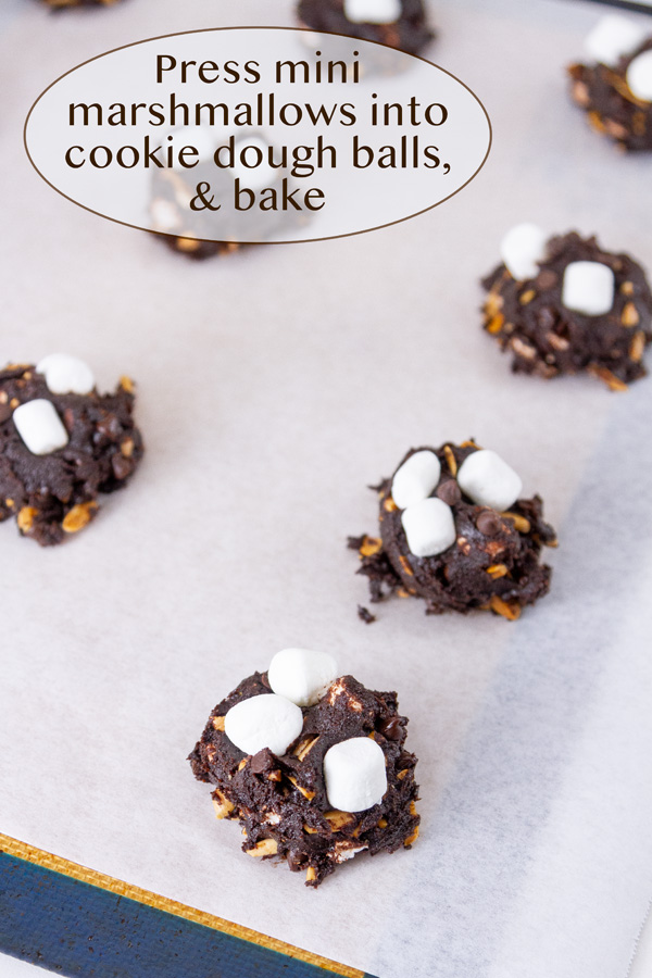 pressing marshmallows into the cookies.