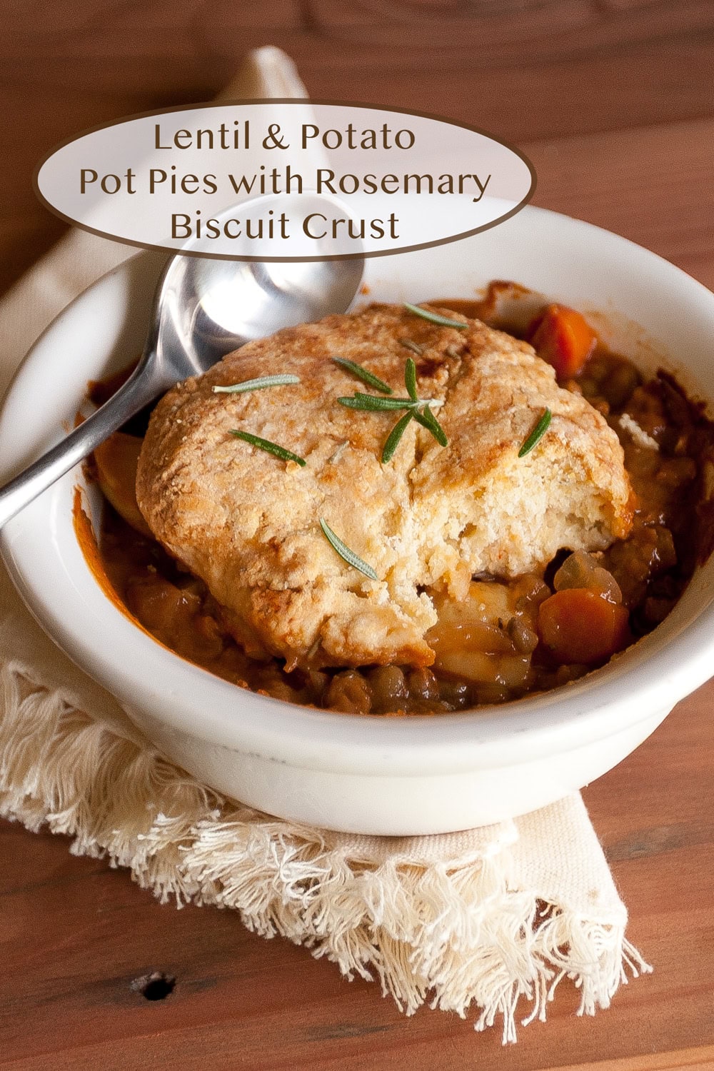 a lentil pot pie in a white dish with a spoon.