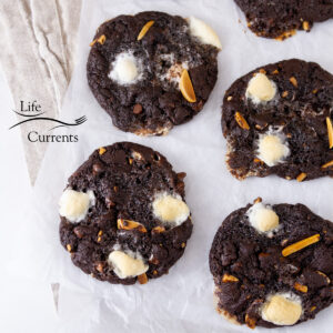 square crop looking down on some chocolate cookies on a piece of parchment paper.