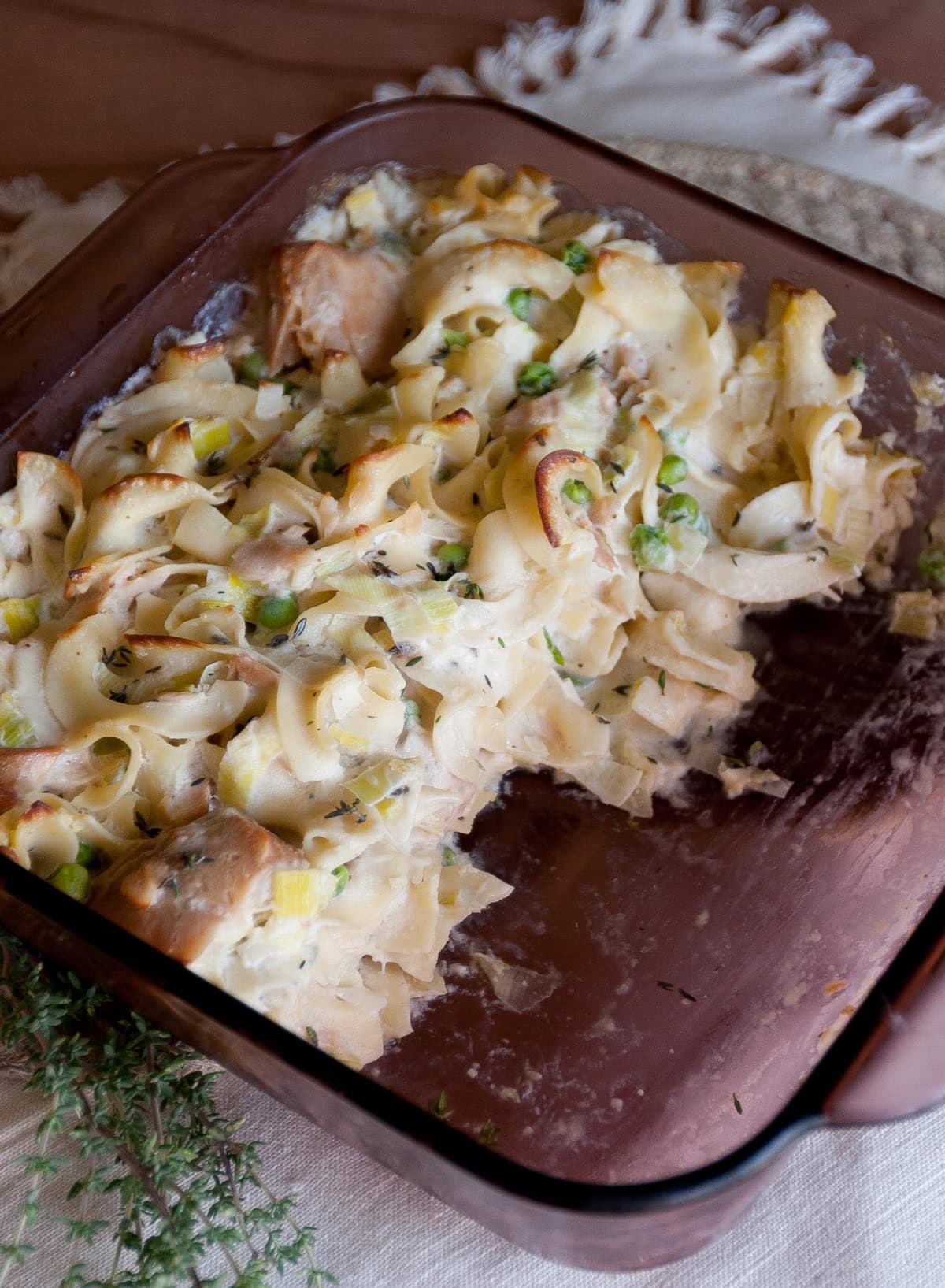 the casserole dish with the baked tuna casserole, some of it has been served.