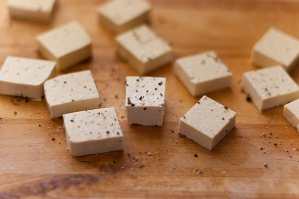 Autumnal Salad Salt & Pepper Seared Tofu, Thyme Roasted Sweet Potatoes with Marcona Almonds, and Avocados served on a bed of Spinach and Red Cabbage cubed tofu seasoned lightly with salt and pepper
