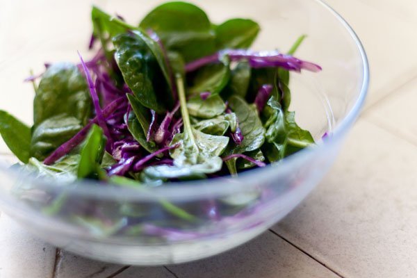 Autumnal Salad Salt & Pepper Seared Tofu, Thyme Roasted Sweet Potatoes with Marcona Almonds, and Avocados served on a bed of Spinach and Red Cabbage spinach salad with red cabbage