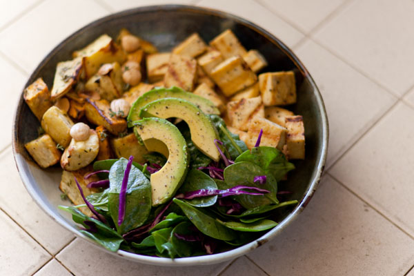 Autumnal Salad Salt & Pepper Seared Tofu, Thyme Roasted Sweet Potatoes with Marcona Almonds, and Avocados served on a bed of Spinach and Red Cabbage