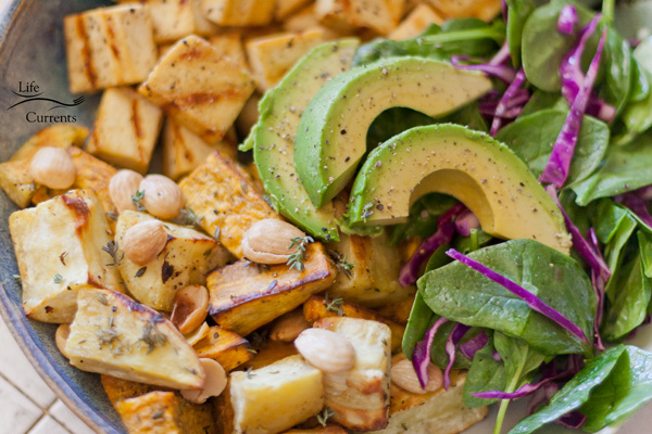 Autumnal Salad Salt & Pepper Seared Tofu, Thyme Roasted Sweet Potatoes with Marcona Almonds, and Avocados served on a bed of Spinach and Red Cabbage