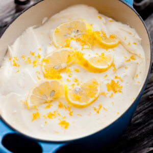 dessert in a casserole dish garnished with lemon slices.