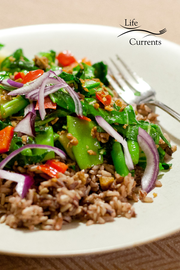 rice and veggies in a bowl with a fork