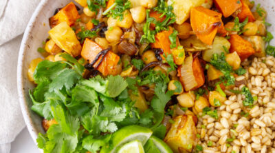 square crop, image contains food, grains, vegetabes, cilantro, lime wedges.