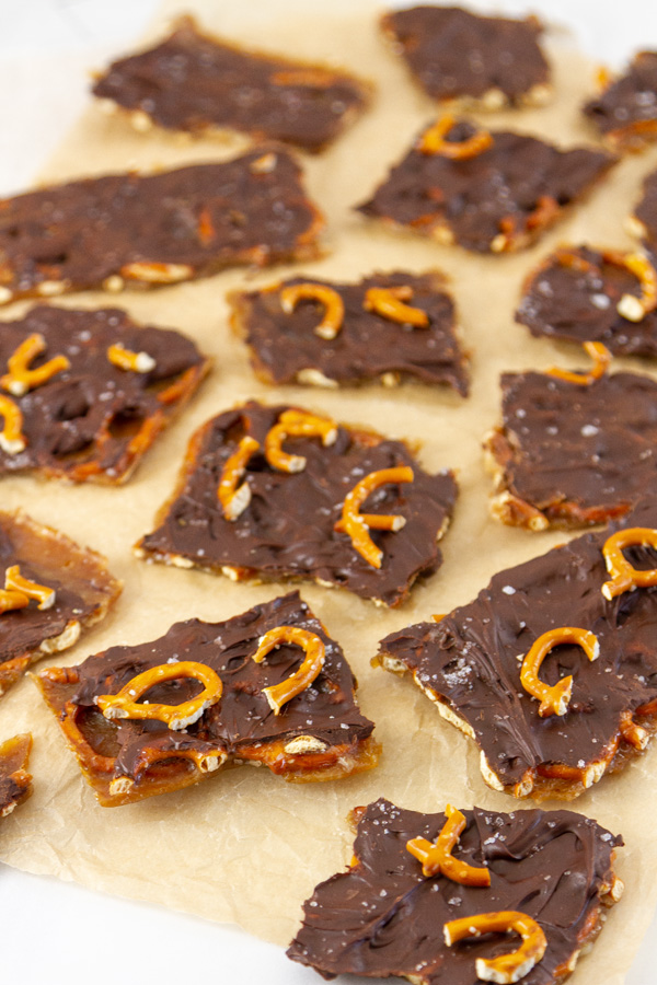 lots of pieces of toffee bark on a sheet or parchment paper.