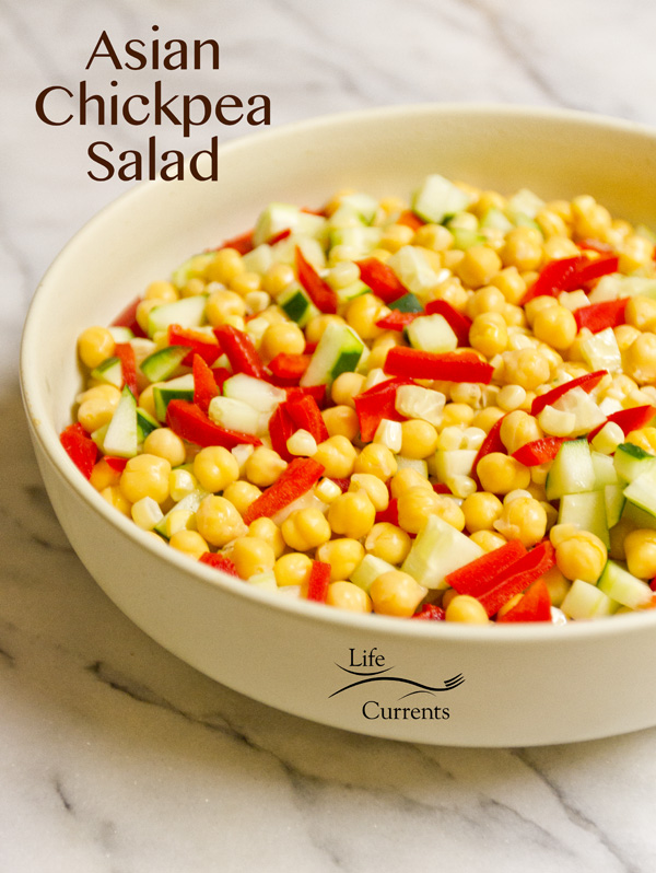 Asian Chickpea Salad salad with garbanzo beans, corn, red pepper, and cucumber in a large bowl on white marble.