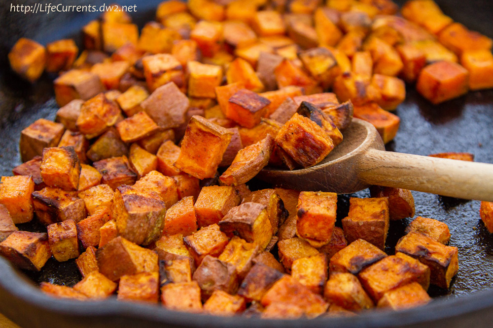 cubed sweet potatoes in a skillet.