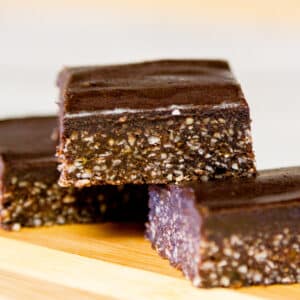 square crop of carob bars stacked on top of each other.
