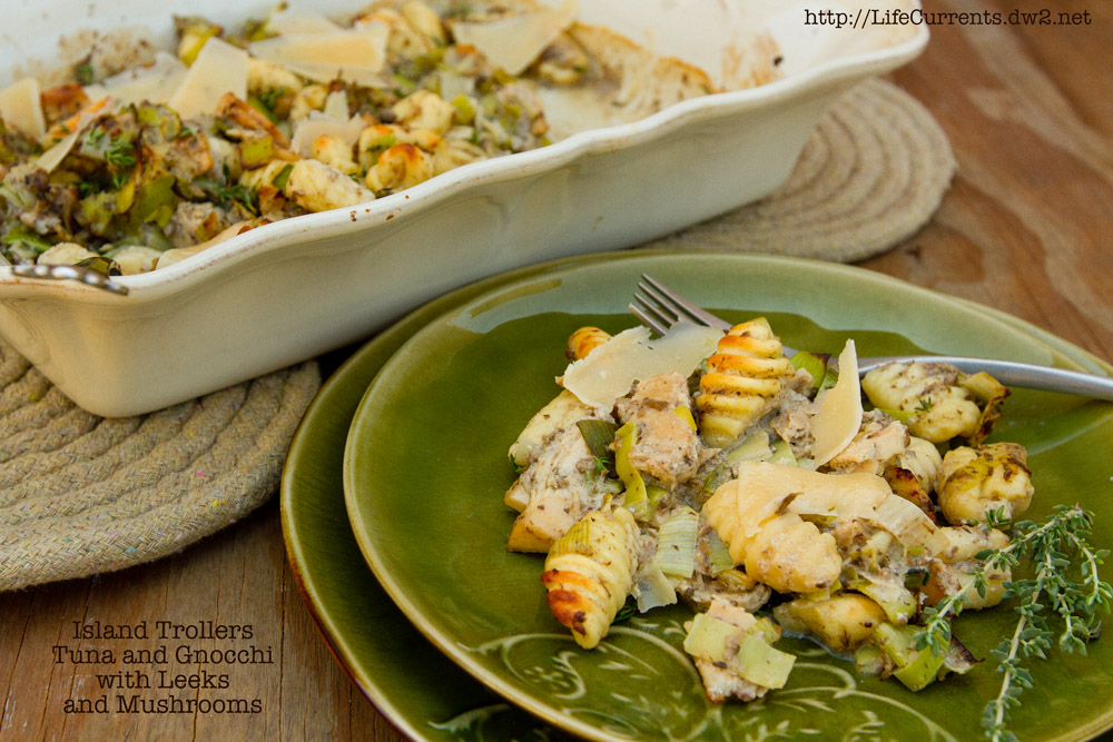 casserole on a plate next to the casserole in the baking dish.
