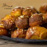 square crop of pretzel bites stacked on a serving plate.