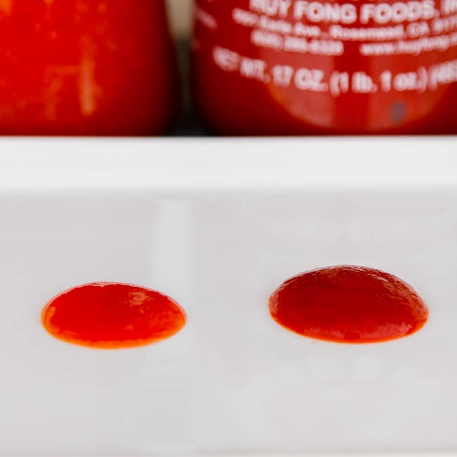 testing homemade sauce vs. bottled sauce with drops on a white plate.
