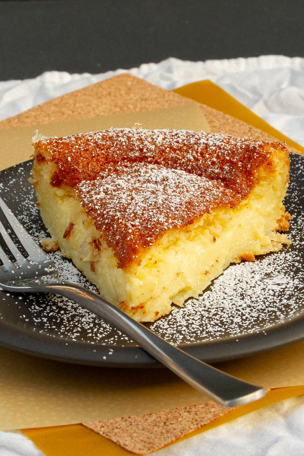 a slice of 123 pie on a black plate with a fork.