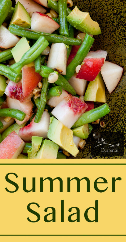 a bowl full of fresh fruits and veggies like peaches, corn, green beans, avocado.