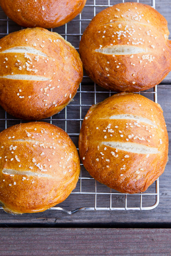 bread rolls with sea salt on top on a wire rack.