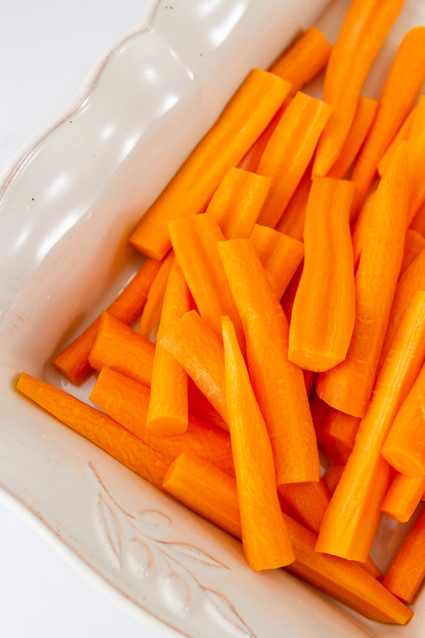 raw cut carrots in a roasting dish