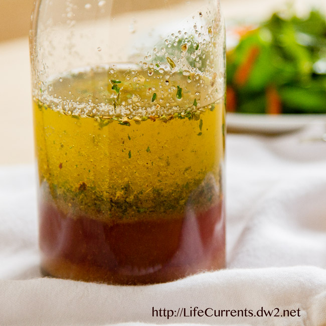Close up on a bottle of separated oil and vinegar to make dressing.