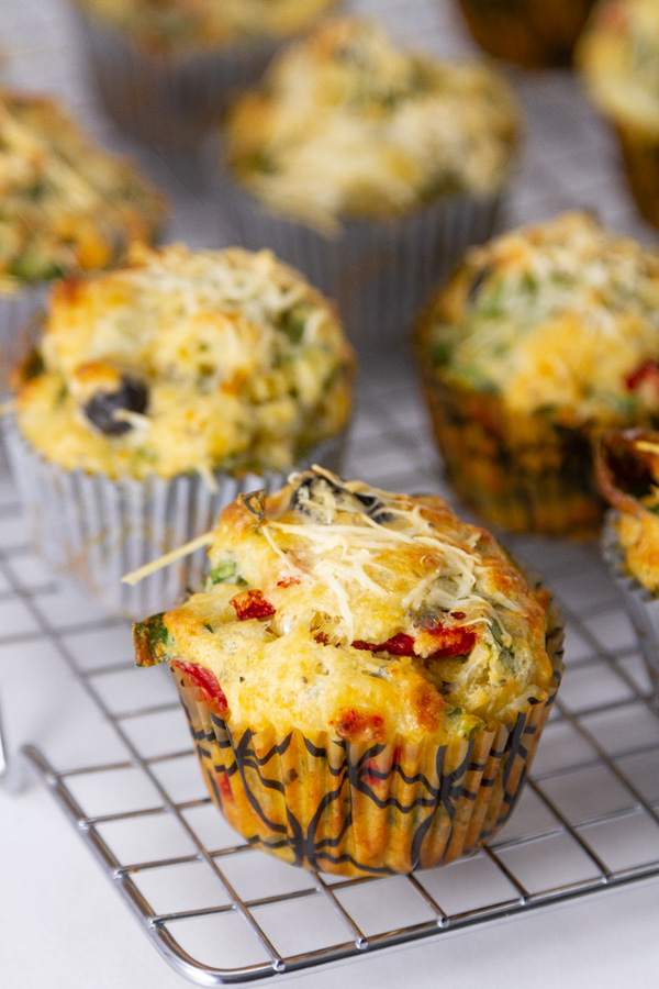 muffins in paper cups on a cooling rack.