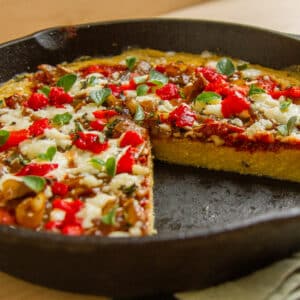 a thick crust pizza in a cast iron skillet.