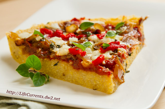 a slice of pizza with lots of toppings on a white plate.