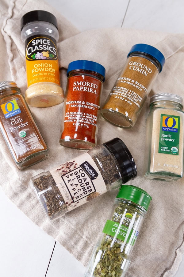 spice jars laid out on a cloth napkin.